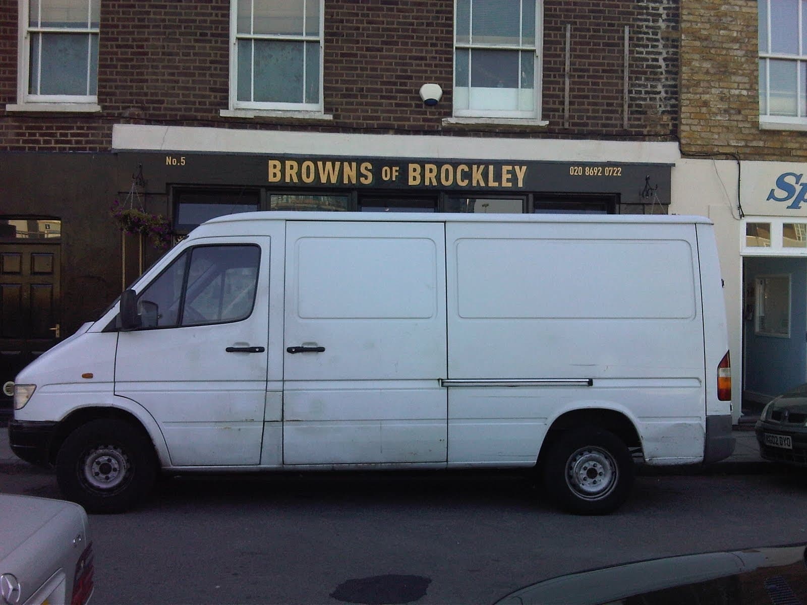 A large white van parked directly in front of Browns of Brockley, hiding the shopfront
